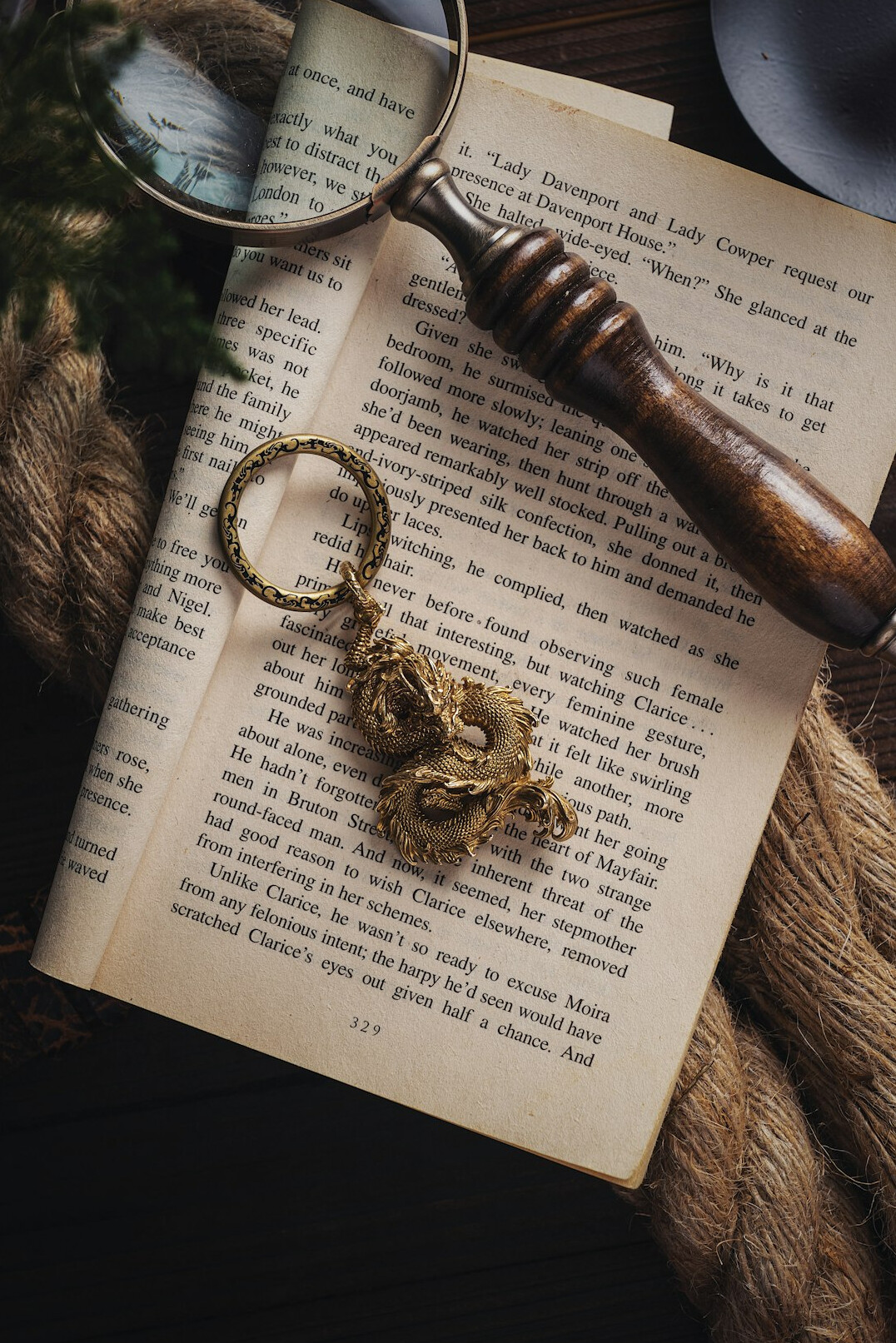 Detective notebook with magnifying glass and old photographs on a wooden desk