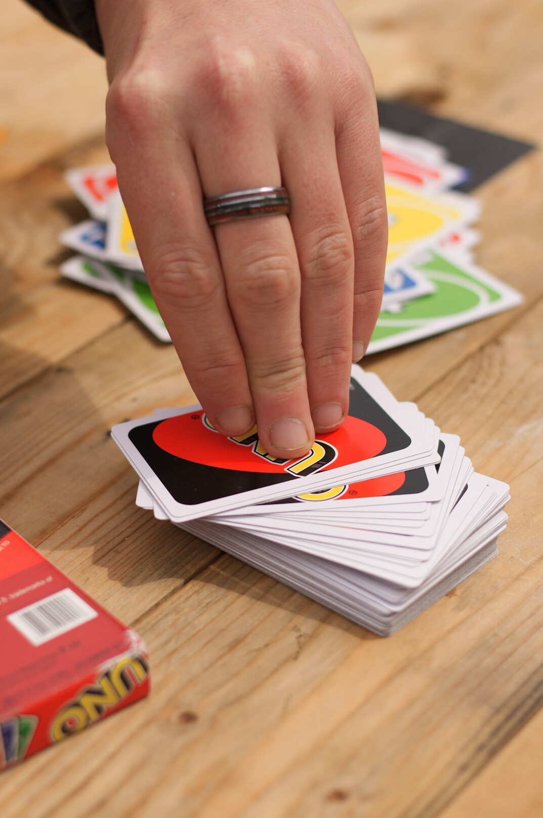 Hands arranging index cards and clues on a wooden table