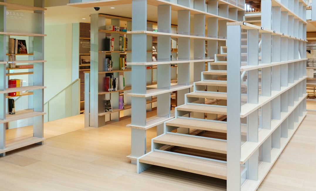 Old library archive with tall wooden shelves full of books