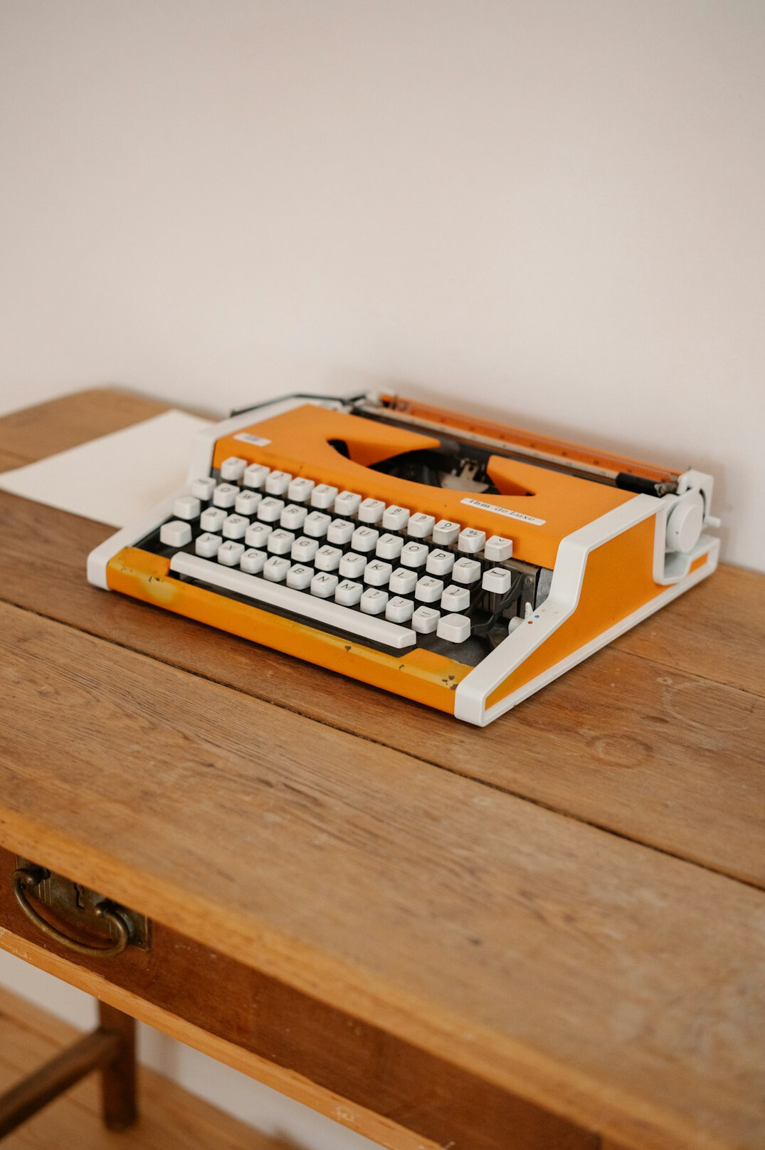 Vintage typewriter and stack of papers on an editor's desk